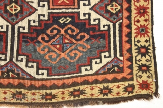 Antique caucasian zakatala ivory ground long rug. Complete and original with an unusual border arrangement showing no outer minor. Original dark wool or goat hair selvages. Almost black wefting. All natural colors  ...