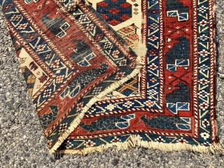 Antique Caucasian ivory ground rug with an eye catch design of very colorful large boteh and a marasali type border with “chessmen”  or bird motifs. Mostly decent low pile but scattered  ...