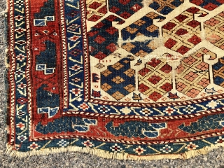 Antique Caucasian ivory ground rug with an eye catch design of very colorful large boteh and a marasali type border with “chessmen”  or bird motifs. Mostly decent low pile but scattered  ...