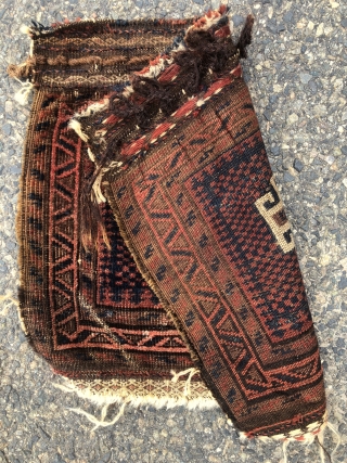 Antique little Baluch bagface with an interesting design feature. The single bold memling gul floats on an unusual checked ground. Overall good even pile. Some brown  oxidation. Creases. Natural colors. Original  ...