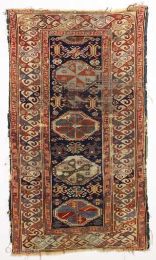 Antique caucasian kuba rug. Reasonably early example with an eye catching "dragons tooth" border and very archaic field motifs. All natural colors featuring several blues and a lovely yellow. Pile varies from  ...