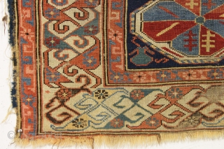Antique caucasian kuba rug. Reasonably early example with an eye catching "dragons tooth" border and very archaic field motifs. All natural colors featuring several blues and a lovely yellow. Pile varies from  ...