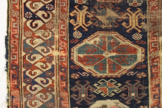 Antique caucasian kuba rug. Reasonably early example with an eye catching "dragons tooth" border and very archaic field motifs. All natural colors featuring several blues and a lovely yellow. Pile varies from  ...
