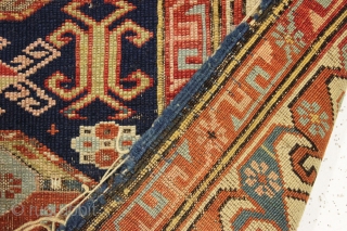 Antique caucasian kuba rug. Reasonably early example with an eye catching "dragons tooth" border and very archaic field motifs. All natural colors featuring several blues and a lovely yellow. Pile varies from  ...