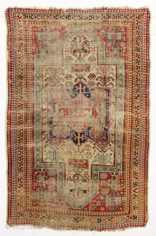 Ghostly antique caucasian rug with an interesting design featuring an unusual border. "As found", thin with allover wear. Appears to have all good original colors. Archaic drawing and not restorable. An interesting  ...