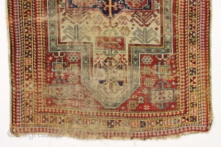 Ghostly antique caucasian rug with an interesting design featuring an unusual border. "As found", thin with allover wear. Appears to have all good original colors. Archaic drawing and not restorable. An interesting  ...