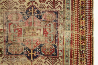 Ghostly antique caucasian rug with an interesting design featuring an unusual border. "As found", thin with allover wear. Appears to have all good original colors. Archaic drawing and not restorable. An interesting  ...