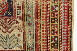 Ghostly antique caucasian rug with an interesting design featuring an unusual border. "As found", thin with allover wear. Appears to have all good original colors. Archaic drawing and not restorable. An interesting  ...