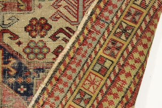 Ghostly antique caucasian rug with an interesting design featuring an unusual border. "As found", thin with allover wear. Appears to have all good original colors. Archaic drawing and not restorable. An interesting  ...