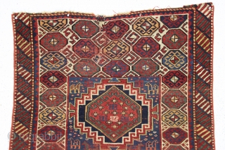 antique kazak with an unusual, if not unique design. The center reserve seems to be a diminutive version of a well known design but the surrounding field is quite eyecatching and inventive.  ...