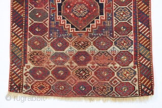 antique kazak with an unusual, if not unique design. The center reserve seems to be a diminutive version of a well known design but the surrounding field is quite eyecatching and inventive.  ...