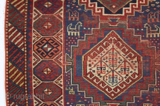 antique kazak with an unusual, if not unique design. The center reserve seems to be a diminutive version of a well known design but the surrounding field is quite eyecatching and inventive.  ...