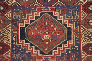 antique kazak with an unusual, if not unique design. The center reserve seems to be a diminutive version of a well known design but the surrounding field is quite eyecatching and inventive.  ...