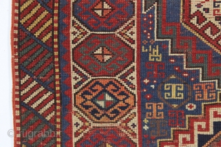 antique kazak with an unusual, if not unique design. The center reserve seems to be a diminutive version of a well known design but the surrounding field is quite eyecatching and inventive.  ...