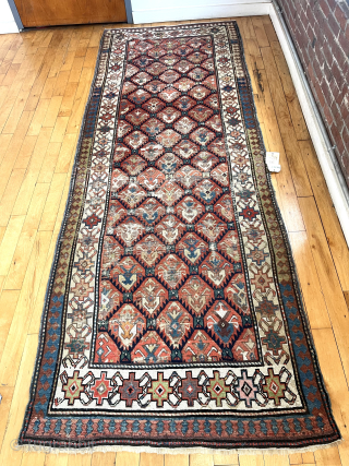 Lovely old long rug with all over tulip palmette design field. Fresh New England find with old cleaning tag from 2005. Scattered wear as shown. No holes. I see some very small  ...