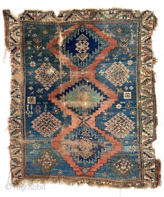 Yikes! Fork, spoon and knife? A fish? Antique Kazak rug in very poor condition with classic field and borders. Wear, holes, edge loss. As found, very dirty. Hard to be sure but  ...