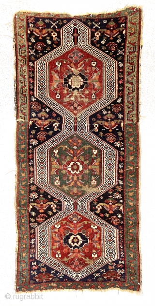 Antique little rug fragment with jewel like color featuring rich greens and lovely purples. Mostly good pile with scattered wear and brown oxidation. The piece constructed of two smaller fragments sewn together.  ...