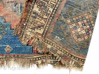 Yikes! Fork, spoon and knife? A fish? Antique Kazak rug in very poor condition with classic field and borders. Wear, holes, edge loss. As found, very dirty. Hard to be sure but  ...