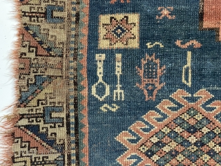 Yikes! Fork, spoon and knife? A fish? Antique Kazak rug in very poor condition with classic field and borders. Wear, holes, edge loss. As found, very dirty. Hard to be sure but  ...