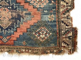 Yikes! Fork, spoon and knife? A fish? Antique Kazak rug in very poor condition with classic field and borders. Wear, holes, edge loss. As found, very dirty. Hard to be sure but  ...