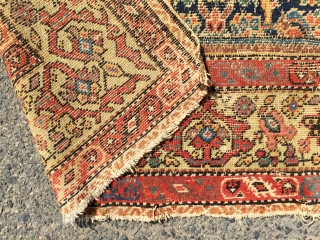 What remains of a genuine antique Persian ferrahan rug. Thin with overall very low pile. Tears, holes and scattered old repairs as shown. Pretty apple green border. Not restorable, good for patches  ...