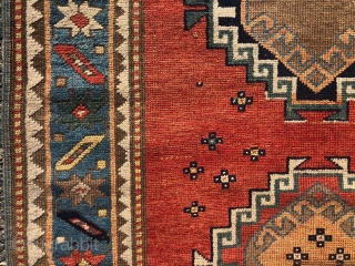 Antique small Kazak rug in good untouched condition with spacious drawing featuring charming large stylized humans. All natural colors including an attractive tomato red ground, sky blue border and an unusual lovely  ...