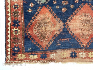 Large Kazak rug. Early? You decide. You might find it exciting or think rubbish and impossible to appreciate. An encyclopedia of condition issues including heavy wear and a good hole.  4’7”  ...