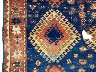 Large Kazak rug. Early? You decide. You might find it exciting or think rubbish and impossible to appreciate. An encyclopedia of condition issues including heavy wear and a good hole.  4’7”  ...