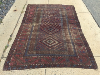 Antique Baluch main carpet. Overall low pile with heavy brown oxidation. All natural colors featuring nice light electric blue highlights. Reasonably clean and intact older example. Nice supple handle and I see  ...
