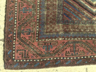 Antique Baluch main carpet. Overall low pile with heavy brown oxidation. All natural colors featuring nice light electric blue highlights. Reasonably clean and intact older example. Nice supple handle and I see  ...