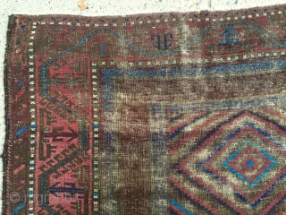 Antique Baluch main carpet. Overall low pile with heavy brown oxidation. All natural colors featuring nice light electric blue highlights. Reasonably clean and intact older example. Nice supple handle and I see  ...