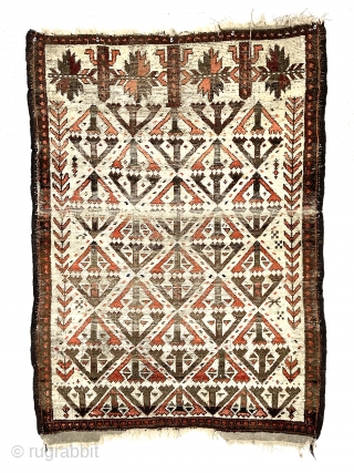 Antique small Baluch rug. Uncommon older ivory ground example. Interesting archaic field design I have not seen before as well as a dramatic design shift surprisingly at the top end. Unusual all  ...