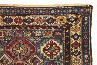 antique kuba rug with an unusually large variety of designs in the field. The overall effect is of great delicacy and i don't think one could fit in much more. Overall pretty  ...