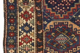 antique kuba rug with an unusually large variety of designs in the field. The overall effect is of great delicacy and i don't think one could fit in much more. Overall pretty  ...