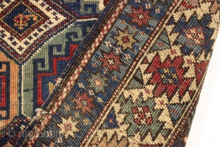 antique kuba rug with an unusually large variety of designs in the field. The overall effect is of great delicacy and i don't think one could fit in much more. Overall pretty  ...