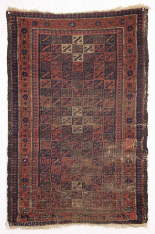 antique baluch rug. Something of an unusual design with all those z's. All good colors with some camel wool pile. "as found", very dirty with wear and old patch as shown and  ...