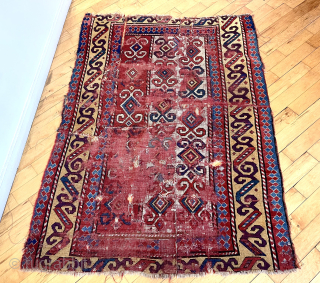Early Kazak rug. Unusual and archaic drawing. Beautiful color including rich yellows and real purple. Battered and distressed. Heavy wear, tears and holes.  Priced accordingly. Interesting study piece. To me it’s  ...