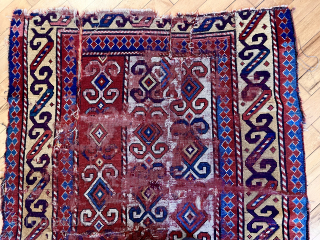 Early Kazak rug. Unusual and archaic drawing. Beautiful color including rich yellows and real purple. Battered and distressed. Heavy wear, tears and holes.  Priced accordingly. Interesting study piece. To me it’s  ...