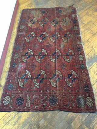 Antique Tekke main carpet fragment. As found with wear, stains, patches, reduced size. All natural colors. Storage clean out and priced accordingly. Good age, ca. 1870 or earlier. 3'8" x 6'7"  