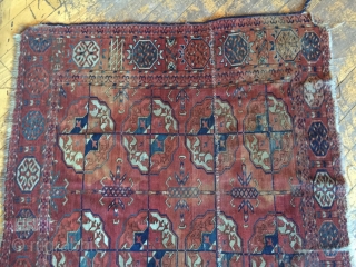 Antique Tekke main carpet fragment. As found with wear, stains, patches, reduced size. All natural colors. Storage clean out and priced accordingly. Good age, ca. 1870 or earlier. 3'8" x 6'7"  