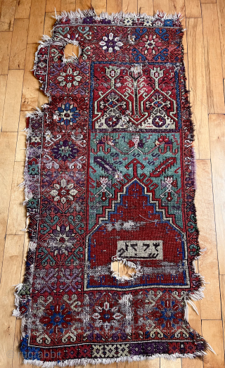 Early Anatolian prayer rug fragment with an unusual inscribed panel. Dated? Great color. Condition as shown. Needs mounting. Great project.  
Early 19th c. 2’7” x 5’ 6”     