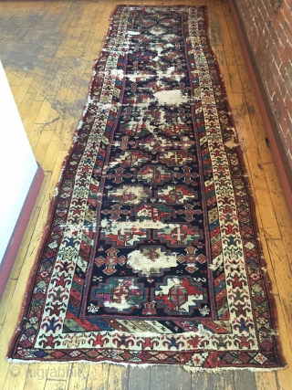 Antique tribal long rug, probably veramin, with terrific drawing featuring an attractive archaic border. All natural colors. Washed and clean. Otherwise as found with scattered heavy wear through out as shown. Storage  ...