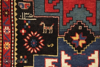 antique kazak rug in excellent condition with inscribed date 1305 (1887). Bold lesghi star design with charming animals and what looks to be a full blown fireworks display. All natural colors featuring  ...