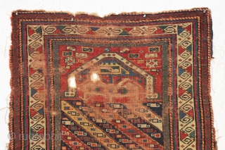 early kazak prayer rug with an unusual mihrab and a very attractive main border. As found, very, very dirty with low pile and scattered damage a shown. Unclear inscribed date. All good  ...