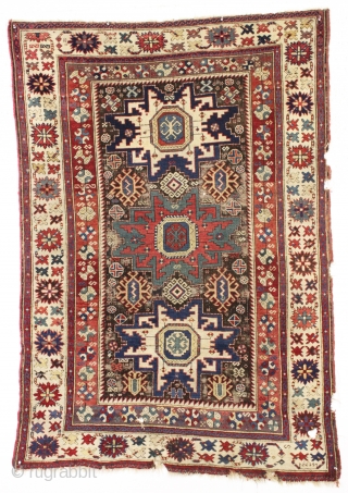 antique caucasian rug, probably kuba, with bold lesghi stars and the complex drawing that indicates good age. As found, mostly good pile elements on a very corroded brown ground. Some scattered damage  ...