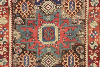 antique caucasian rug, probably kuba, with bold lesghi stars and the complex drawing that indicates good age. As found, mostly good pile elements on a very corroded brown ground. Some scattered damage  ...