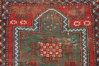 Early kazak prayer rug with true green field. Archaic field elements and bold eye catching ivory border. All good natural colors featuring a beautiful old green, a fine red, multiple blues and  ...