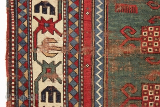 Early kazak prayer rug with true green field. Archaic field elements and bold eye catching ivory border. All good natural colors featuring a beautiful old green, a fine red, multiple blues and  ...