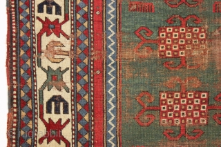 Early kazak prayer rug with true green field. Archaic field elements and bold eye catching ivory border. All good natural colors featuring a beautiful old green, a fine red, multiple blues and  ...