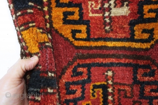 antique liitle pile uzbek or something yastik like object. Coarse weave with long thick pile. Strange palette as shown. Appears to have goat hair warps. Old cloth sleeve sewn on back for  ...